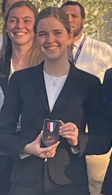 Student holding award