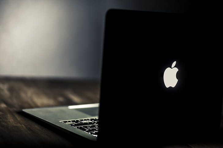 Macbook with lit apple and keyboard